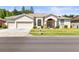 Charming single-story home with a three-car garage, manicured lawn, and inviting curb appeal at 28451 Great Bend Pl, Wesley Chapel, FL 33543