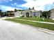 Well-manicured front lawn and clean lines create an attractive home exterior at 28451 Great Bend Pl, Wesley Chapel, FL 33543