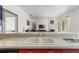 Kitchen features a tiled breakfast bar overlooking the living area with fireplace and pool views at 28451 Great Bend Pl, Wesley Chapel, FL 33543