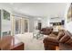 Open concept living room showcasing fireplace, sliding glass doors to outside, and kitchen access at 28451 Great Bend Pl, Wesley Chapel, FL 33543