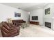 Living room has plush seating, fireplace and television, offering a comfortable gathering space at 28451 Great Bend Pl, Wesley Chapel, FL 33543