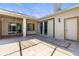 Back patio featuring tile flooring, ceiling fan, and doors with decorative blue trim at 28451 Great Bend Pl, Wesley Chapel, FL 33543