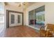 Back patio with tile flooring, ceiling fan, large sliding glass door with view of screened-in pool at 28451 Great Bend Pl, Wesley Chapel, FL 33543