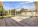 Screened-in pool with clear blue water, tiled patio and view of the backyard at 28451 Great Bend Pl, Wesley Chapel, FL 33543
