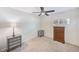 Neutral bedroom with a ceiling fan, a window, and a mirrored-drawer nightstand next to a dark wood dresser at 2933 Bough Ave # C, Clearwater, FL 33760