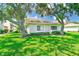 Charming single story condo with lush green lawn and mature shade trees on property at 2933 Bough Ave # C, Clearwater, FL 33760