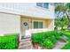 Charming condo featuring a well-maintained exterior, a welcoming door, and lush, mature landscaping at 2933 Bough Ave # C, Clearwater, FL 33760
