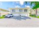 Condo with attached two-car garage, second story balcony, and well-maintained landscaping at 2933 Bough Ave # C, Clearwater, FL 33760