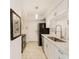 Modern kitchen with white cabinetry, stainless steel appliances, and tiled flooring at 2933 Bough Ave # C, Clearwater, FL 33760