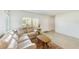 Bright living room with a comfortable sofa, stylish rug, and tile floors at 2933 Bough Ave # C, Clearwater, FL 33760