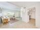 Open-concept living room flowing into dining area, with ample natural light and tile flooring at 2933 Bough Ave # C, Clearwater, FL 33760