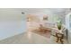 Inviting living room with neutral tile floors, a leather sofa, and bright, airy windows at 2933 Bough Ave # C, Clearwater, FL 33760