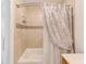 Tiled shower and tub combination featuring a shower curtain and built-in soap and shampoo dispenser at 2933 Bough Ave # C, Clearwater, FL 33760