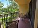 Relaxing balcony with outdoor seating and view of mature trees offering privacy at 3062 Eastland Blvd # 105, Clearwater, FL 33761