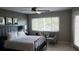 This primary bedroom features a ceiling fan, natural light, and tile floors at 3062 Eastland Blvd # 105, Clearwater, FL 33761