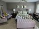 This lovely bedroom offers a black metal bed frame, neutral walls and floors, and ample light at 3062 Eastland Blvd # 105, Clearwater, FL 33761