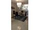 Inviting dining area featuring a glass table, chandelier, and a mirror, creating an elegant ambiance at 3062 Eastland Blvd # 105, Clearwater, FL 33761