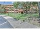 Beautiful condo building with lush landscaping and a well-maintained lawn, enhanced by mature trees and plants at 3062 Eastland Blvd # 105, Clearwater, FL 33761