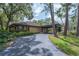 Charming home features a circular driveway and a covered carport entrance with mature landscaping at 3062 Eastland Blvd # 105, Clearwater, FL 33761
