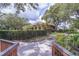 View of the building framed by lush greenery and a decorative fence for added privacy at 3062 Eastland Blvd # 105, Clearwater, FL 33761