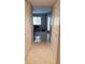 Light, bright hallway with tile floors, leading to bedroom and large windows at 3062 Eastland Blvd # 105, Clearwater, FL 33761