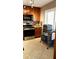 Traditional kitchen with wood cabinets, granite countertops and stainless steel appliances and tile floors at 3062 Eastland Blvd # 105, Clearwater, FL 33761