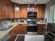 Traditional kitchen with wood cabinets, granite countertops, mosaic backsplash and stainless appliances at 3062 Eastland Blvd # 105, Clearwater, FL 33761