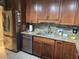Renovated kitchen featuring stainless steel appliances, stylish cabinets, granite counters, and modern sink at 3062 Eastland Blvd # 105, Clearwater, FL 33761
