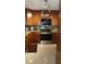 Traditional kitchen with wood cabinets, granite countertops, mosaic backsplash and stainless appliances at 3062 Eastland Blvd # 105, Clearwater, FL 33761