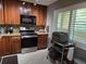 Traditional kitchen with wood cabinets, granite countertops and stainless steel appliances and tile floors at 3062 Eastland Blvd # 105, Clearwater, FL 33761