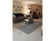 Comfortable living room with sofa, recliner, and modern coffee table on neutral flooring at 3062 Eastland Blvd # 105, Clearwater, FL 33761