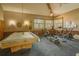 Spacious recreation room with pool table and exercise equipment, illuminated by natural light at 3062 Eastland Blvd # 105, Clearwater, FL 33761