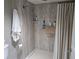 Bathroom shower features a new shower curtain, chrome fixtures and neutral walls at 3062 Eastland Blvd # 105, Clearwater, FL 33761