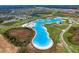 Expansive aerial image of the community's impressive lagoon, landscaping, and residential development at 30739 Penny Surf Loop, Wesley Chapel, FL 33545
