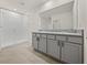 Bathroom featuring a large walk-in shower and double vanity with granite countertops for added convenience at 30739 Penny Surf Loop, Wesley Chapel, FL 33545