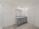 Bright bathroom with double sink vanity, large mirror and tiled floor creating a serene and modern space at 30739 Penny Surf Loop, Wesley Chapel, FL 33545