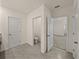 Bathroom area with grey floors, a toilet room, and doorways to other rooms at 30739 Penny Surf Loop, Wesley Chapel, FL 33545