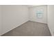 Bedroom featuring carpet, a window with blinds, and neutral walls at 30739 Penny Surf Loop, Wesley Chapel, FL 33545