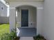 A covered front porch offers shelter and curb appeal for entering the home at 30739 Penny Surf Loop, Wesley Chapel, FL 33545