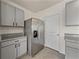 Spacious kitchen area features granite countertops, modern cabinets, and stainless refrigerator at 30739 Penny Surf Loop, Wesley Chapel, FL 33545