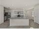 Modern kitchen island features gray cabinets, granite countertops, and stainless appliances at 30739 Penny Surf Loop, Wesley Chapel, FL 33545