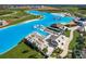 Beautiful aerial view showcasing the lagoon's numerous water features, beach, and surrounding community areas at 30739 Penny Surf Loop, Wesley Chapel, FL 33545