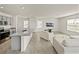 The kitchen and living room feature granite countertops, stainless steel appliances, and a bright, open layout at 30739 Penny Surf Loop, Wesley Chapel, FL 33545