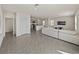 Open-concept living room with tile flooring flows into a modern kitchen, creating a spacious and inviting area at 30739 Penny Surf Loop, Wesley Chapel, FL 33545