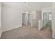 Spacious upper loft area with neutral carpet, multiple entryways, and bright natural light from nearby windows at 30739 Penny Surf Loop, Wesley Chapel, FL 33545
