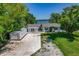 Aerial view of a charming home with a spacious driveway, garage, and lush green lawn at 3113 W Sligh Ave, Tampa, FL 33614
