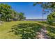 Scenic backyard with a grassy lawn and a view of the lake, perfect for outdoor enjoyment at 3113 W Sligh Ave, Tampa, FL 33614