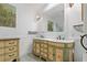 Bathroom boasts dual sinks with decorative cabinetry, and a large mirror perfect for morning preparations at 3113 W Sligh Ave, Tampa, FL 33614