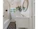 Cozy bathroom features a shower-tub combination, vanity with storage, and decorative mirror at 3113 W Sligh Ave, Tampa, FL 33614