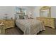 Bedroom features an inviting bed with side tables, lamps, dresser, and a mirror, creating a cozy retreat at 3113 W Sligh Ave, Tampa, FL 33614